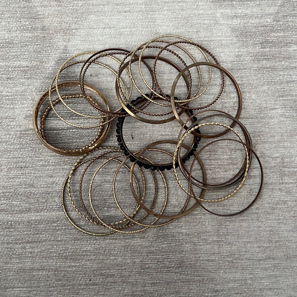 Used 24  bracelets  gold and black beads